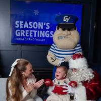 Crying baby with mom with Santa and Louie